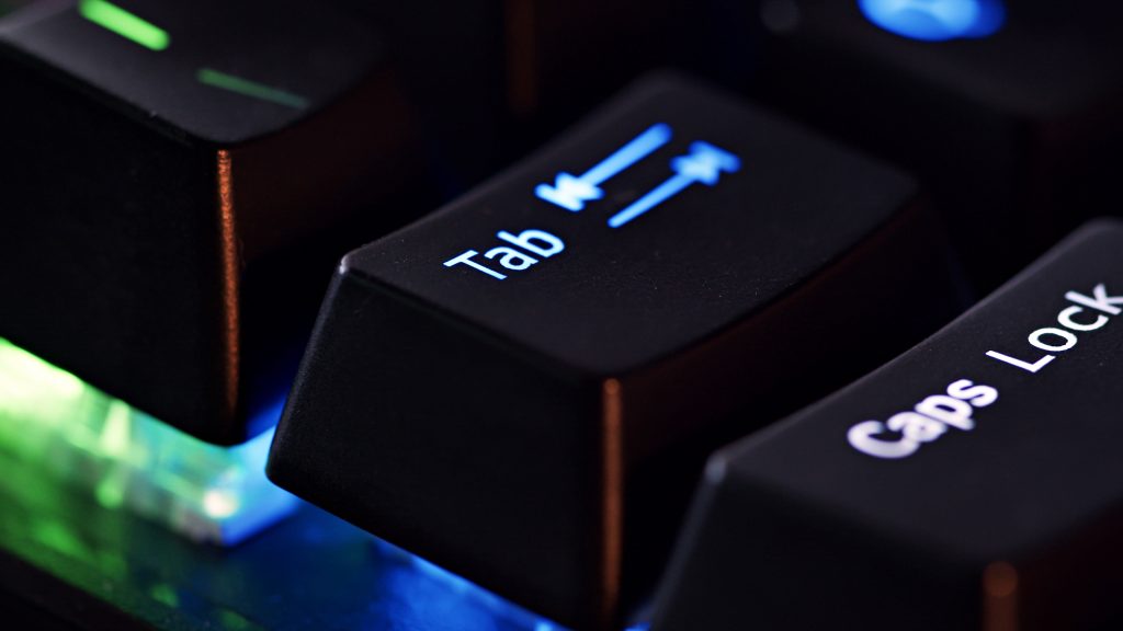 Close-up of an illuminated Tab key on a keyboard, symbolizing how people with disabilities use the Tab key to navigate through web pages and interactive elements without a mouse.